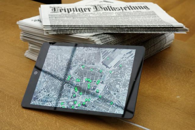 at the exhibition, iPad and newspapers